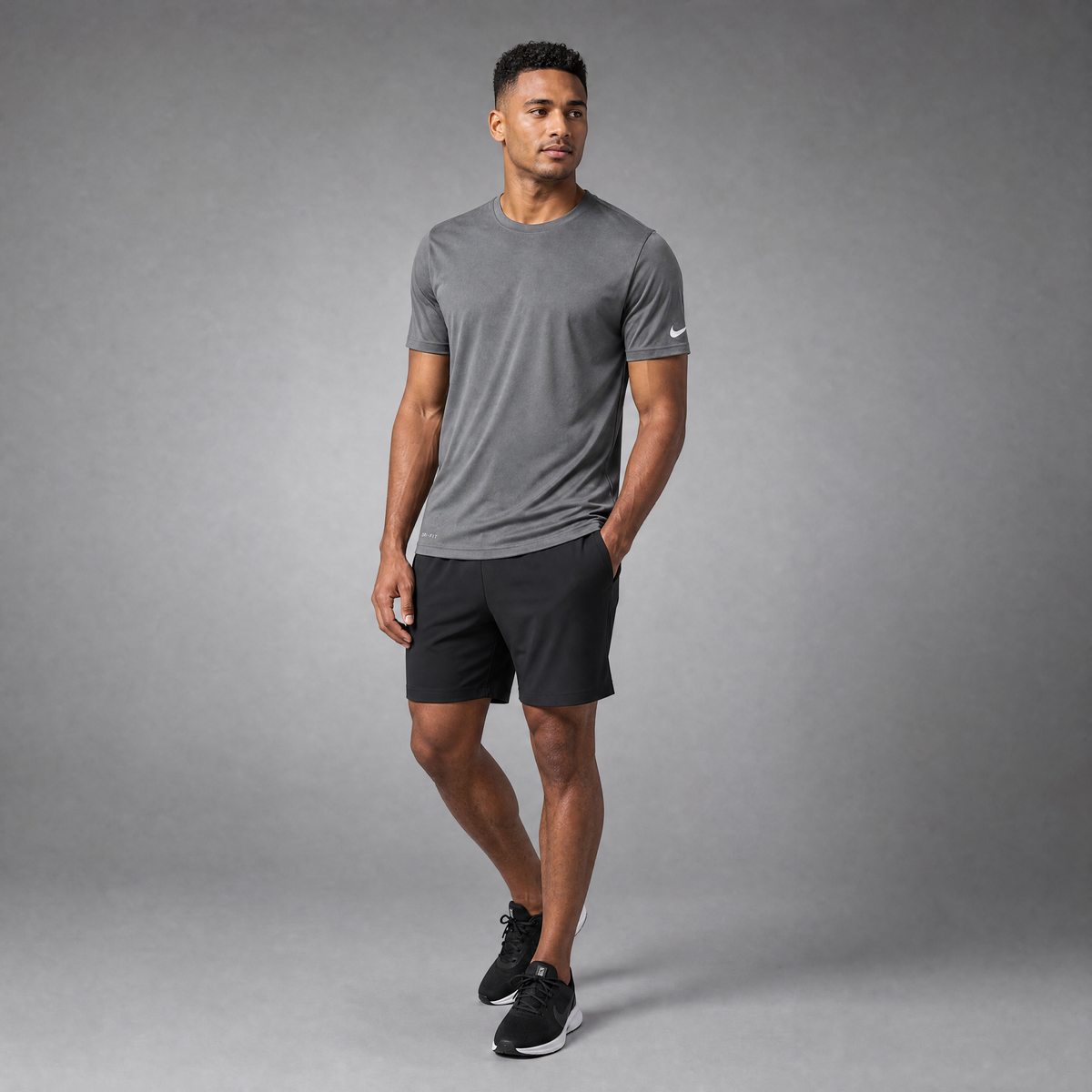 Male athlete modeling the gray Nike Cotton Short Sleeve Men's Tee